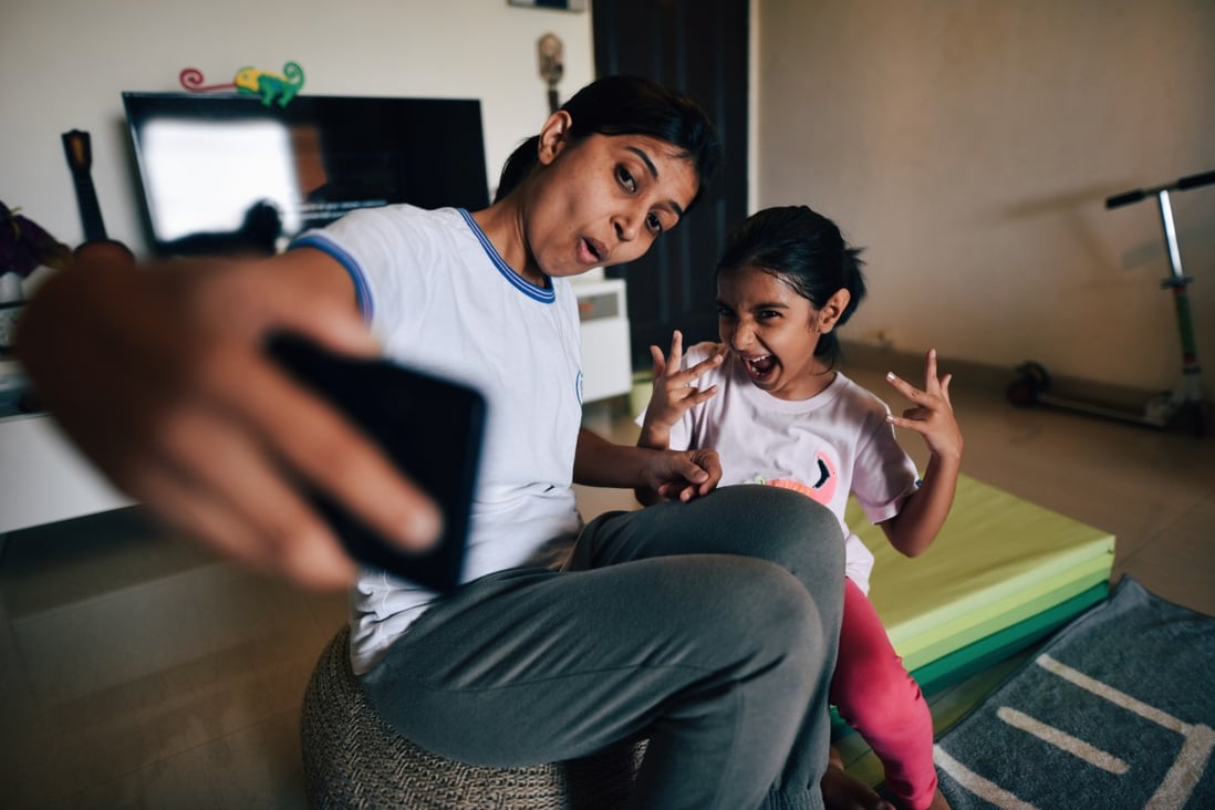 A mother and daughter take a selfie at home. Many parents enjoying posting such images on social media, but what are the implications for the child? Photo: Getty Images