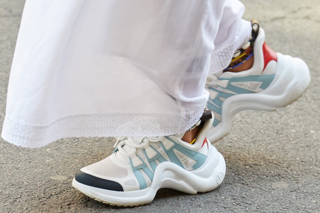 A pair of white and blue Louis Vuitton sneakers worn during Milan Fashion Week in 2018. Designers are increasingly pivoting to creating and selling sneakers as footwear trends move towards casual wear. Photo: Shutterstock