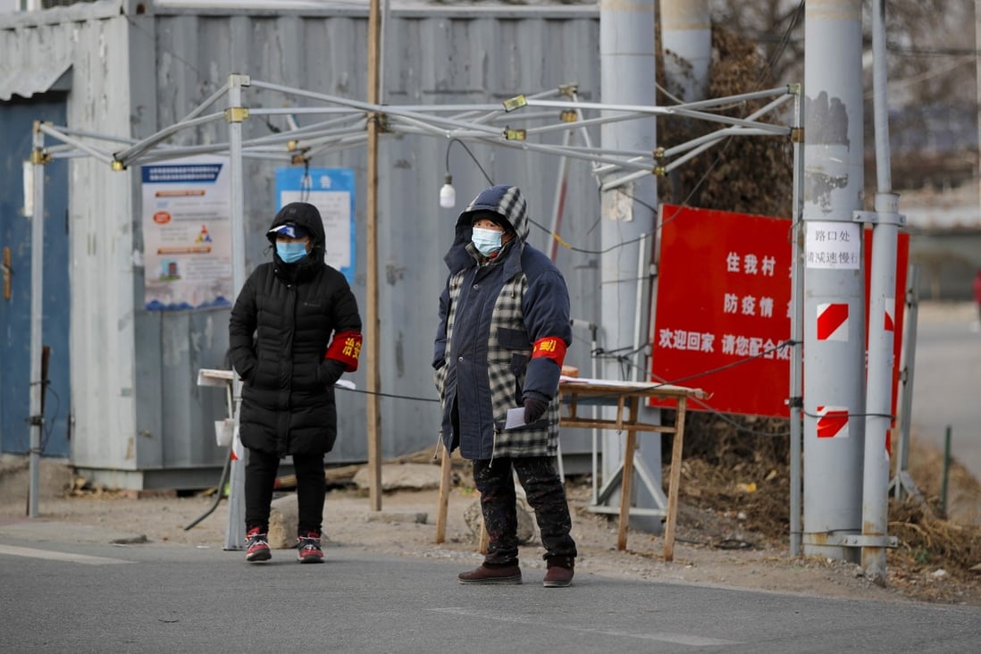 Volunteers man a checkpoint leading to their village on the outskirts of Beijing. Photo: EPA-EFE