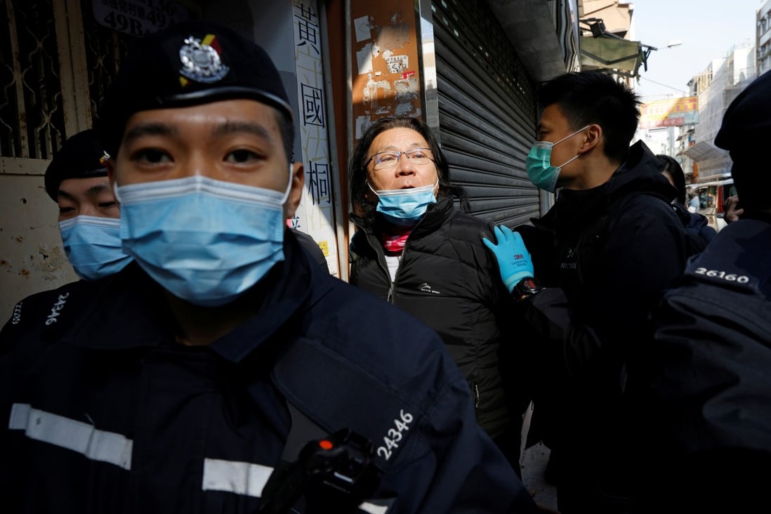 Daniel Wong is escorted by police to his office for a police search on Thursday. Photo: Reuters