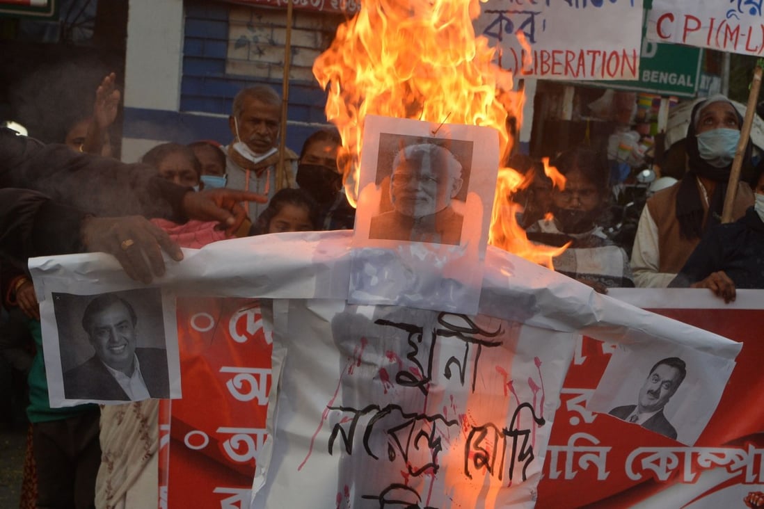 Activists burn effigies of Indian Prime Minister Narendra Modi and billionaires Mukesh Ambani and Gautam Adani during a protest against agricultural reforms. Photo: AFP
