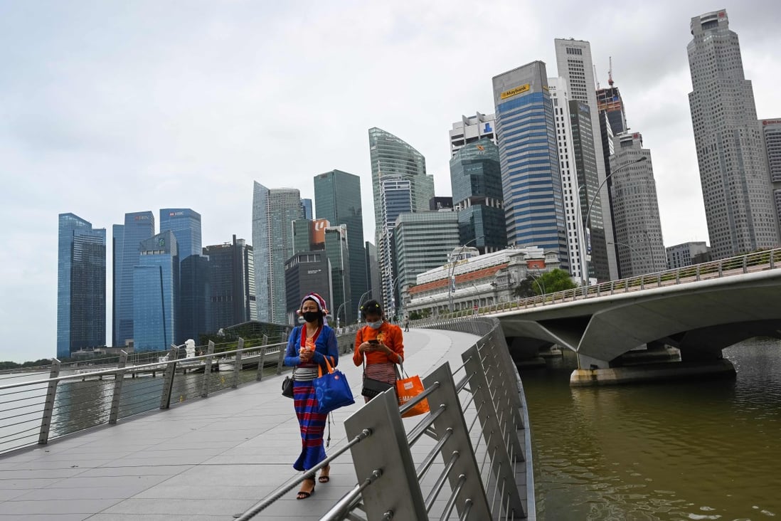 Women walk across a bridge on Marina Bay in Singapore. Photo: AFP