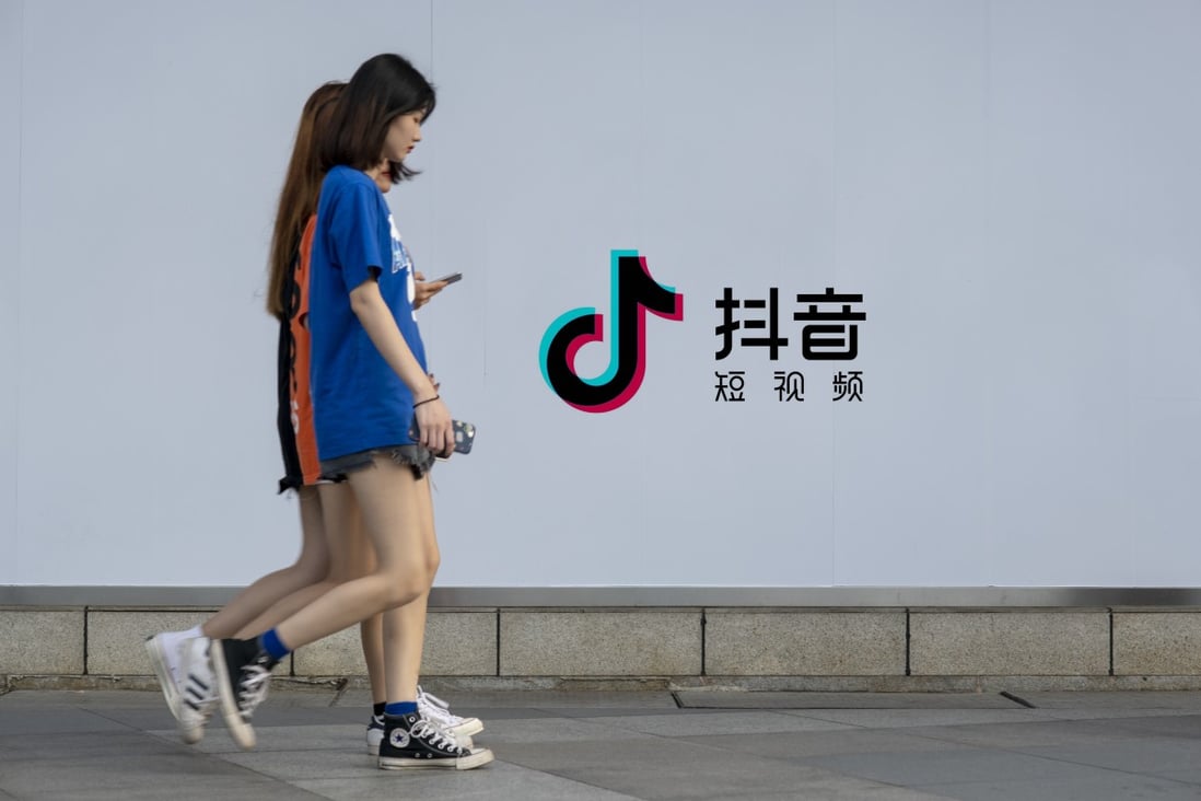 Pedestrians walk past an advertisement for ByteDance-owned short video-sharing platform Douyin, the sister app of TikTok, in the southern Chinese city of Guangzhou. Photo: Imaginechina via Agence France-Presse