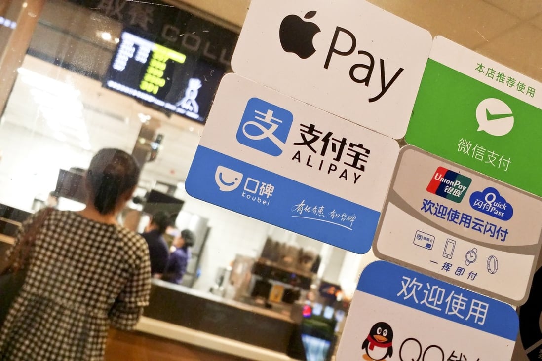 A merchant displaying payment services offered by Apple Pay, Ant Group’s Alipay, WeChat Payment, Tencent QQ and UnionPay at a store in Guangzhou. Photo: SCMP