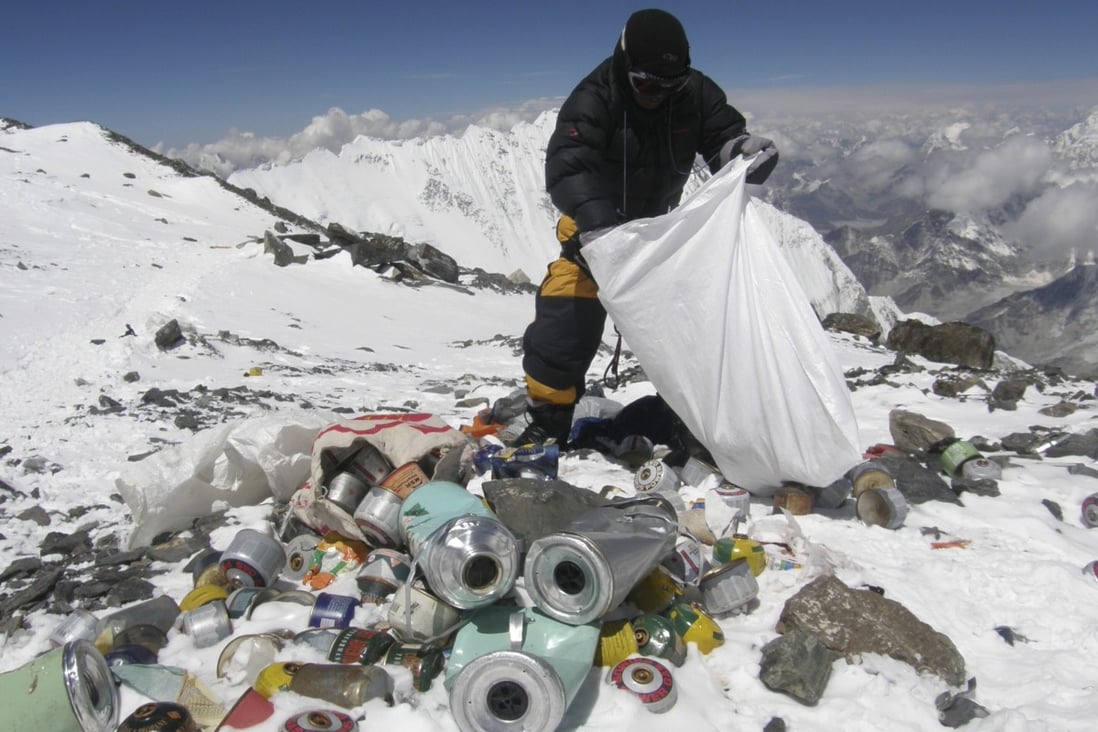 A Nepalese sherpa collects garbage left by climbers at an altitude of 8,000 metres during a Mount Everest clean-up expedition. A local group plans to create art out of some of the waste left at the world’s highest peak. Photo: AFP