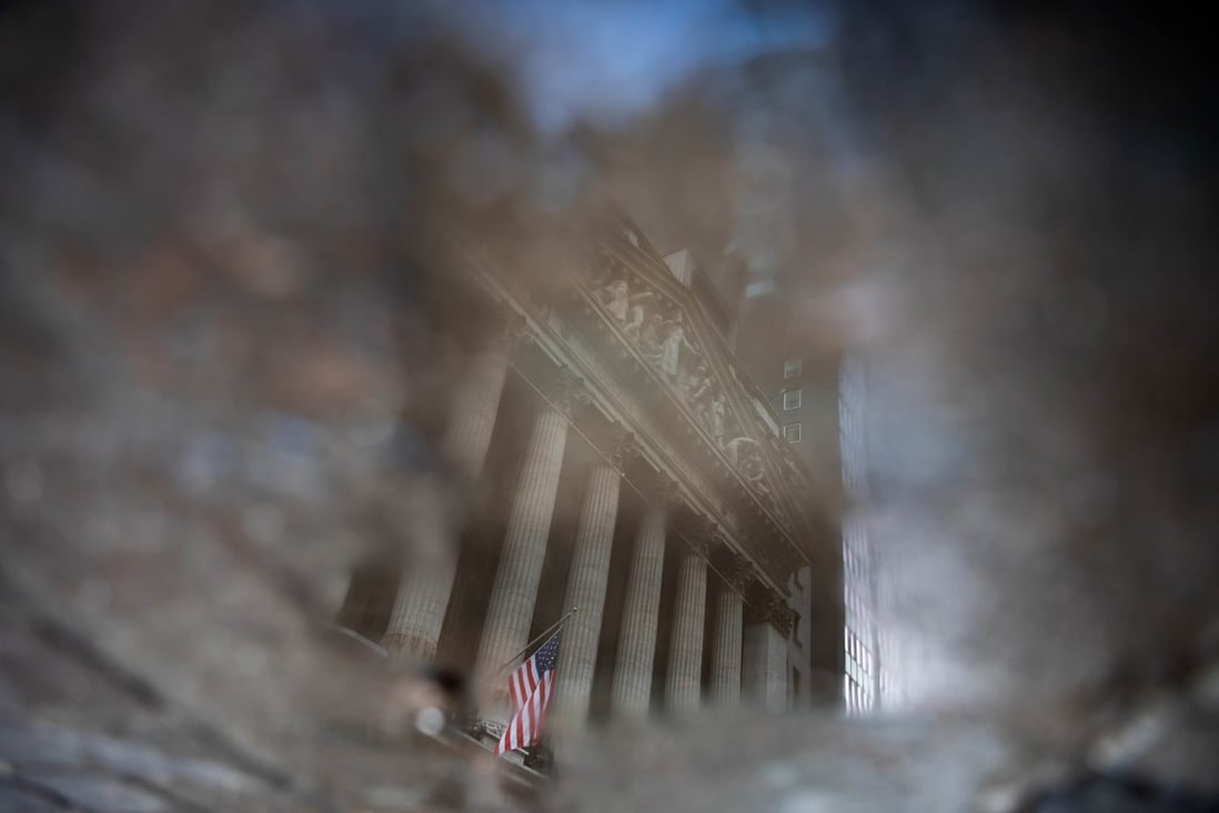 The New York Stock Exchange is reflected in a puddle on January 4. 2020 was a historic year marking a rapid plunge into bear market territory and a swift recovery into the bull zone. Photo: Bloomberg