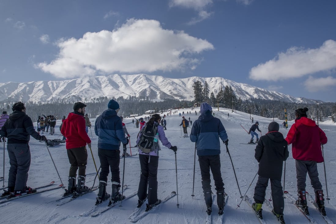 Tourists wait for their turn to use a ski lift on the slopes at Gulmarg, a winter sports resort in Indian-controlled Kashmir. With restrictions on overseas travel because of the coronavirus, domestic tourists have packed out hotels in the hill station to ski, sledge, snowboard and trek. Photo: AP