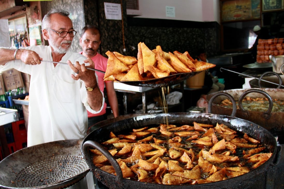 Frying mutton samosa in Bangalore. Samosas are called the “king of snacks” in India, but they originated in Egypt. Photo: Getty Images