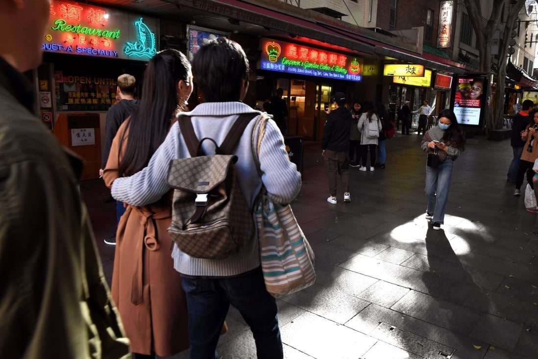 Chinese-Australians walking through the streets of Sydney's Chinatown Photo: AFP