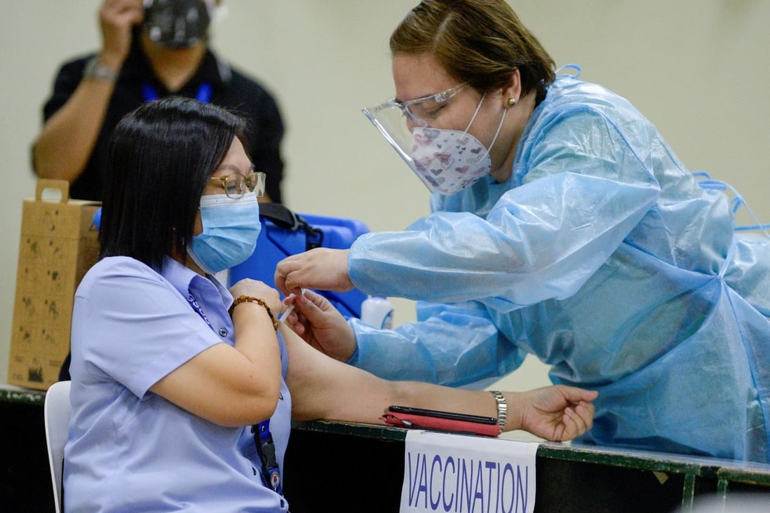 A health worker conducts a mock Covid-19 vaccination during a simulation exercise in Manila. Photo: Reuters