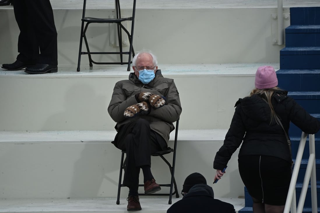 Senator Bernie Sanders sits in the bleachers on Capitol Hill wearing the mittens made for him by Jennifer Ellis, a schoolteacher from Vermont. Photo: AFP