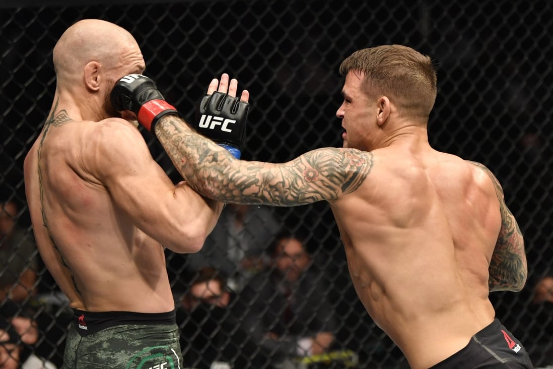 Dustin Poirier punches Conor McGregor in their lightweight fight during UFC 257. Photos: Jeff Bottari/Zuffa LLC