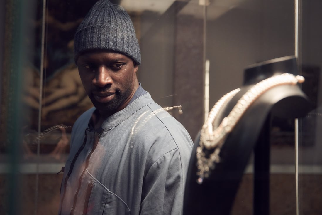 Omar Sy, as Assane Diop in Lupin, sizes up the target of his next heist from the Louvre Museum in the French hit series on Netflix. Photo: TNS