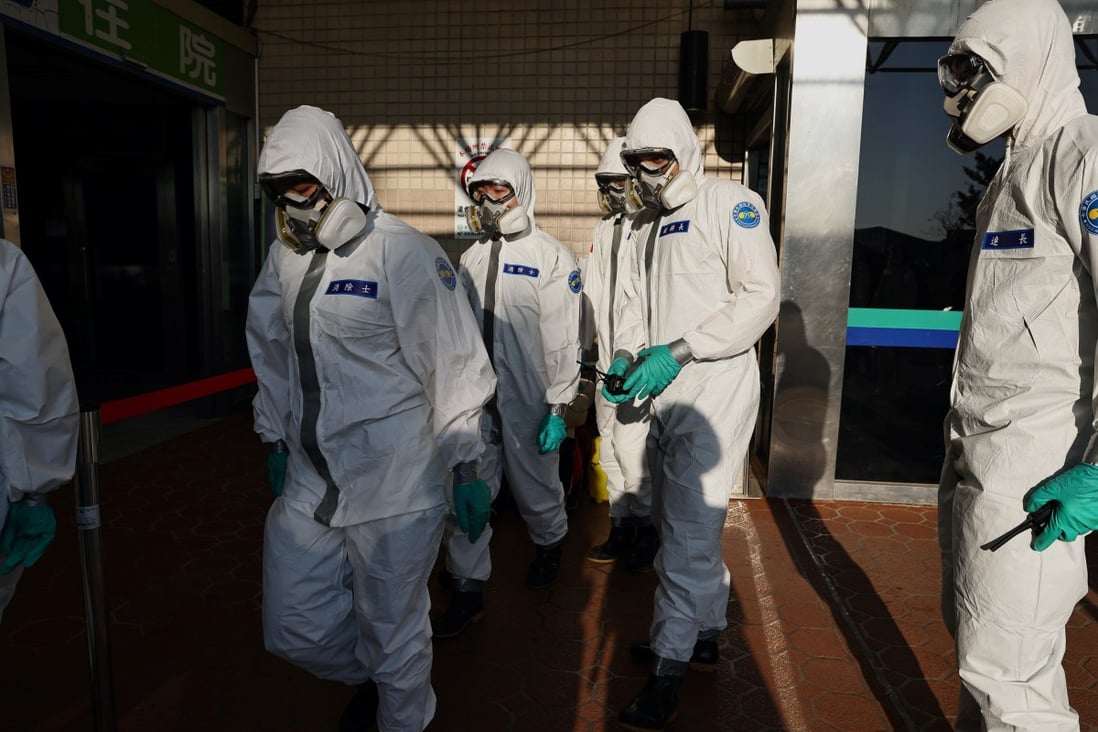 Soldiers prepare to spray disinfectant at the Taoyuan General Hospital. Photo: Reuters