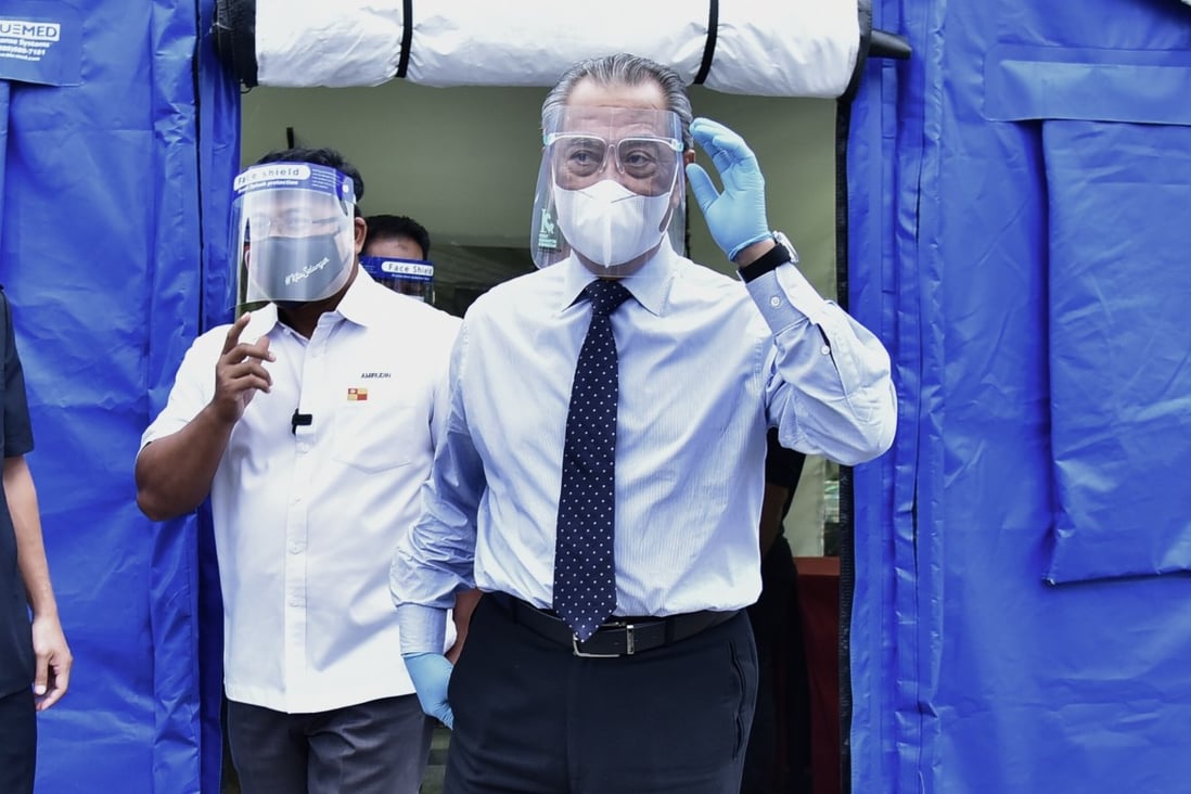 Malaysian Prime Minister Muhyiddin Yassin, centre, visits a Covid-19 treatment and quarantine centre in Serdang earlier this month. Photo: Handout via Xinhua