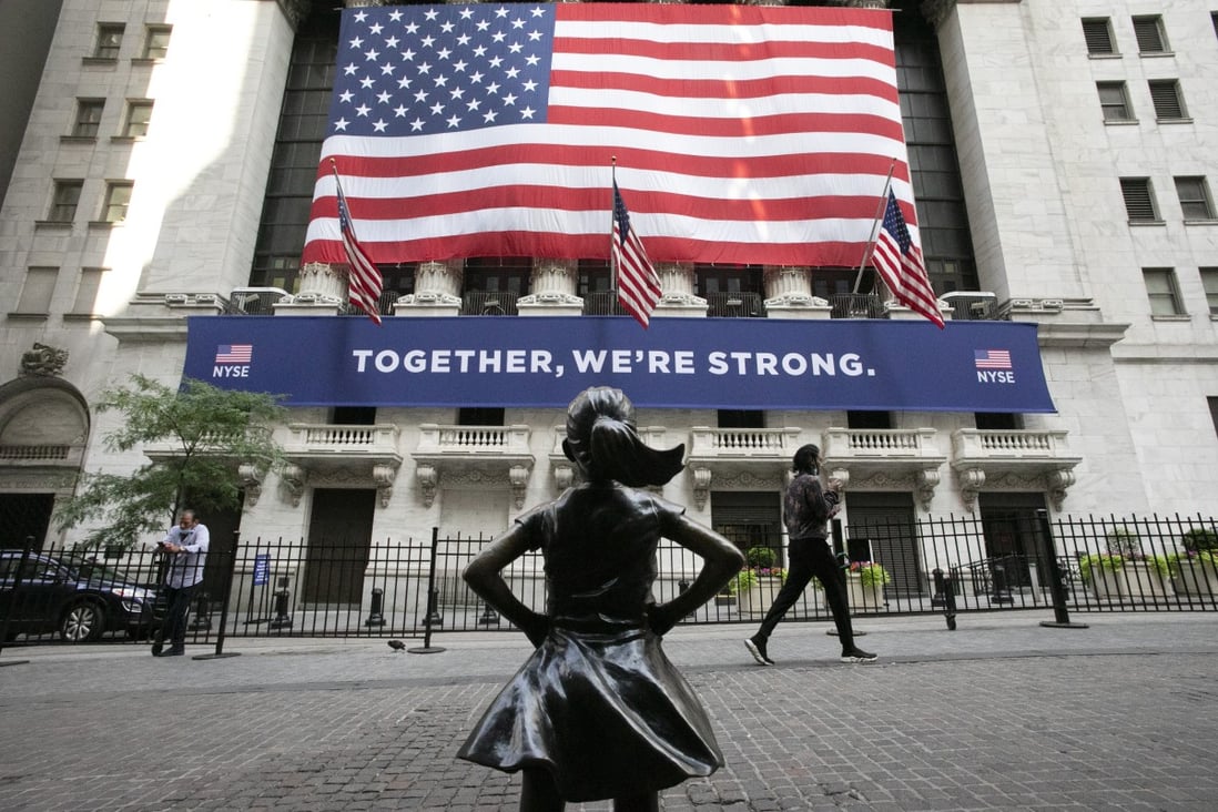 In this July 9, 2020 file photo, the Fearless Girl statue stands in front of the New York Stock Exchange in New York. Wall Street bankers in Asia are enjoying more bonuses that come with a revival in deal flows in the region. Photo: AP
