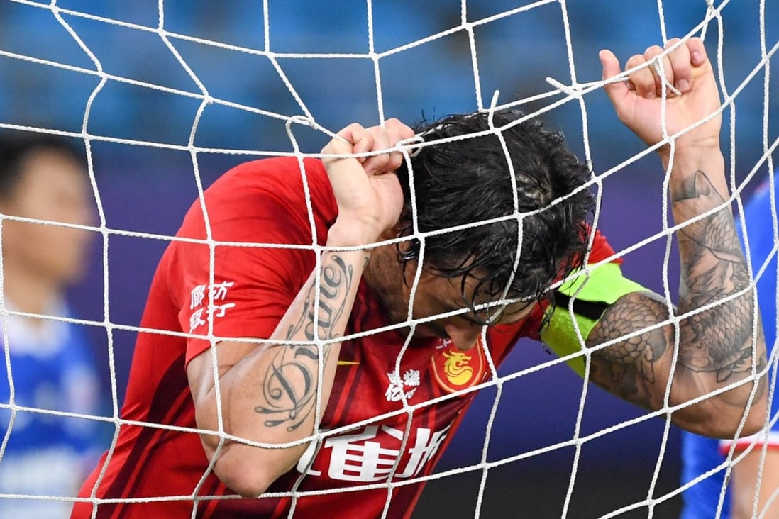 Ricardo Goulart, of Hebei China Fortune FC, hangs in the goal net after missing a chance against Shanghai Shenhua in the 2020 Chinese Super League. Photo: Xinhua