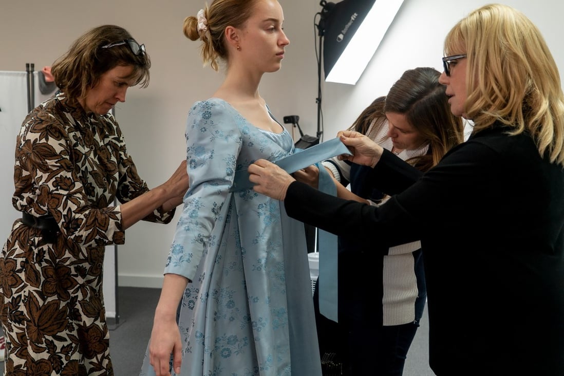 Phoebe Dynevor, who plays Daphne Bridgerton in the Netflix hit Bridgerton, in the show’s costume department as she gets kitted out for a scene. Photo: Liam Daniel/Netflix