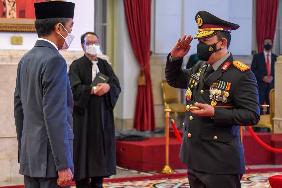 Indonesian President Joko Widodo and General Listyo Sigit Prabowo (R) are seen during the new police chief’s swearing in ceremony at the presidential palace in Jakarta on January 27. Photo: AFP