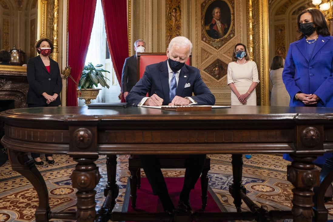 US President Joe Biden signs three documents, including cabinet nominations, in the President’s Room at the Capitol after his inauguration on January 20, as Vice-President Kamala Harris looks on. His proposed cabinet would be the most diverse in US history, if confirmed by the Senate. Photo: AP