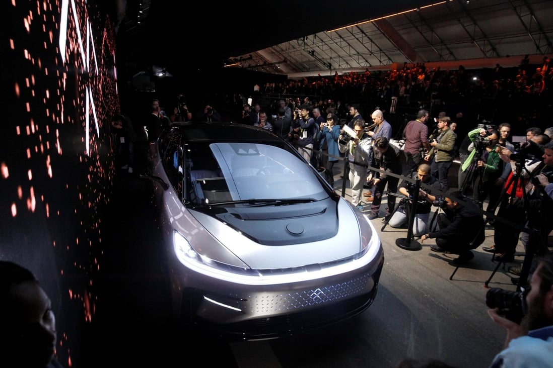 Journalists gather around a Faraday Future FF 91 electric car during an unveiling event at CES in Las Vegas, Nevada, on January 3, 2017. Photo: Reuters