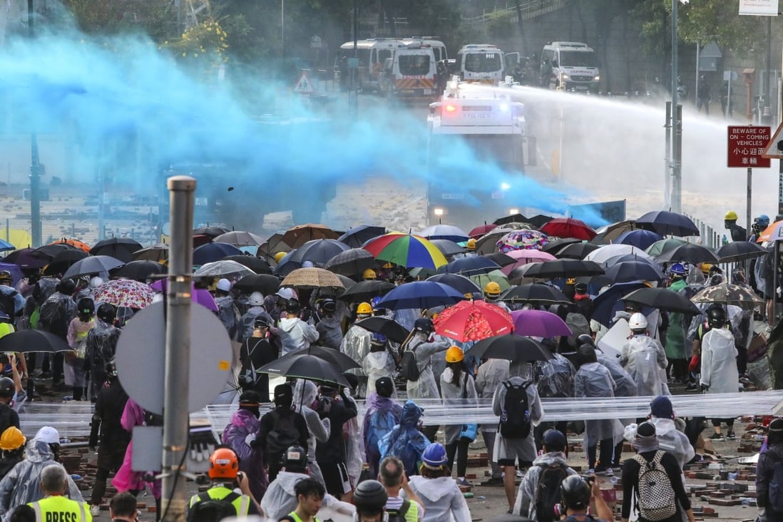 The police used water cannons to spray bright blue pigment to track down protesters. Photo: Felix Wong