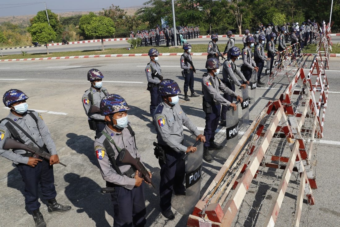 Policemen stand guard behind a road barricade, as a part of security preparations ahead of next week's opening of Myanmar's parliament in Naypyidaw. Photo: AP