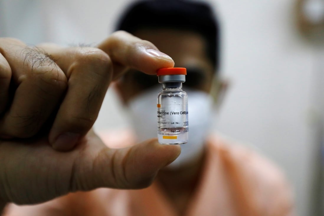An Indonesian doctor with a bottle of the Sinovac coronavirus vaccine. Photo: Reuters