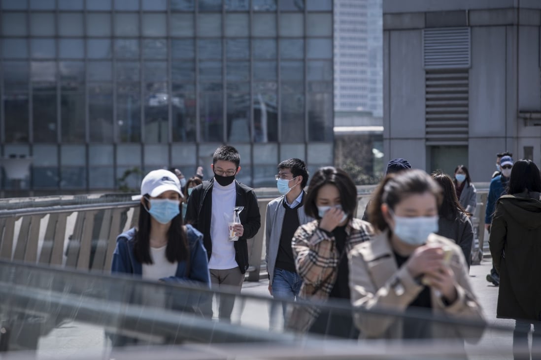 Pedestrians at the Lujiazui Financial District in Shanghai on Friday, March 20, 2020. Photo: Bloomberg