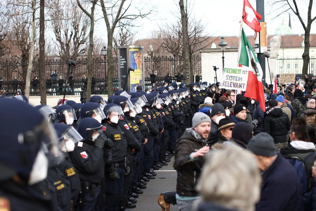 Police officers line up as people gather during a demonstration against coronavirus measures and their economic consequences in Vienna, Austria, on Sunday. Photo: Reuters