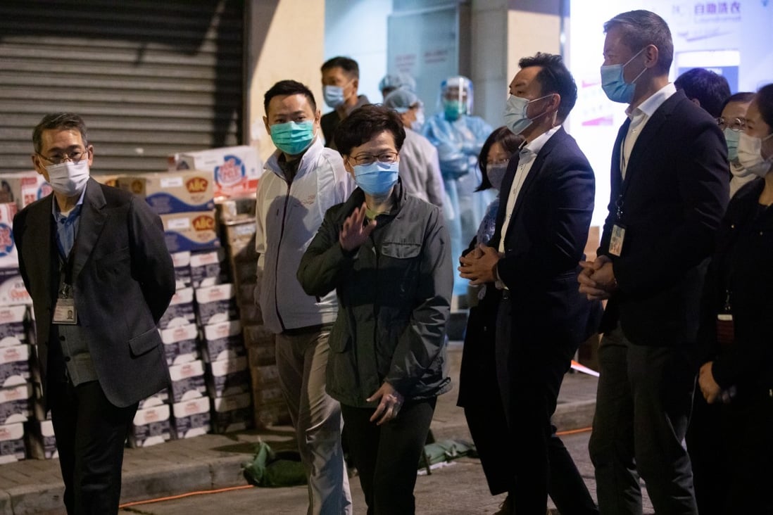 Chief executive Carrie Lam waves to members of the media in an area under lockdown in North Point on January 28. Photo: Bloomberg