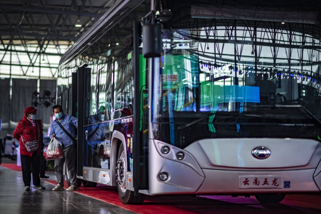Visitors looking at a new energy bus during a promotional activity for new energy vehicles in Beijing. Photo: Xinhua