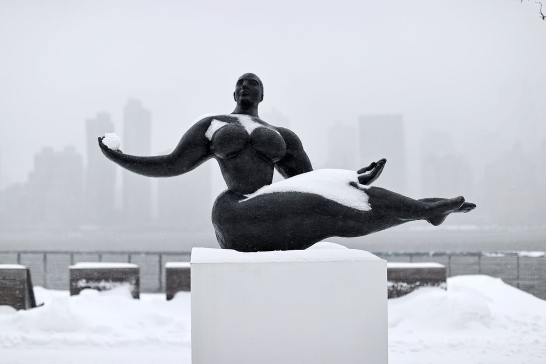 A Floating Woman statue is seen in New York during a winter storm on Monday. Photo: AFP