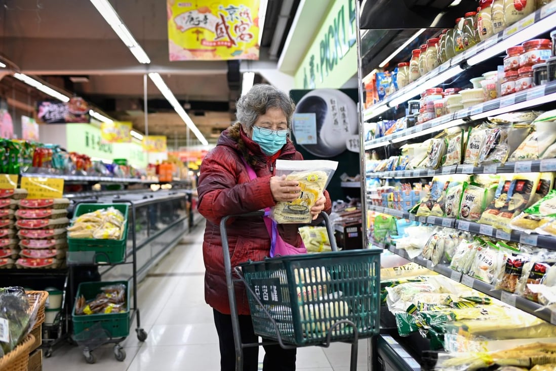 An elderly woman shops in Beijing. The Chinese economy has made a V-shaped recovery from the pandemic, and the government’s emphasis remains on social and financial stability. Photo: AFP