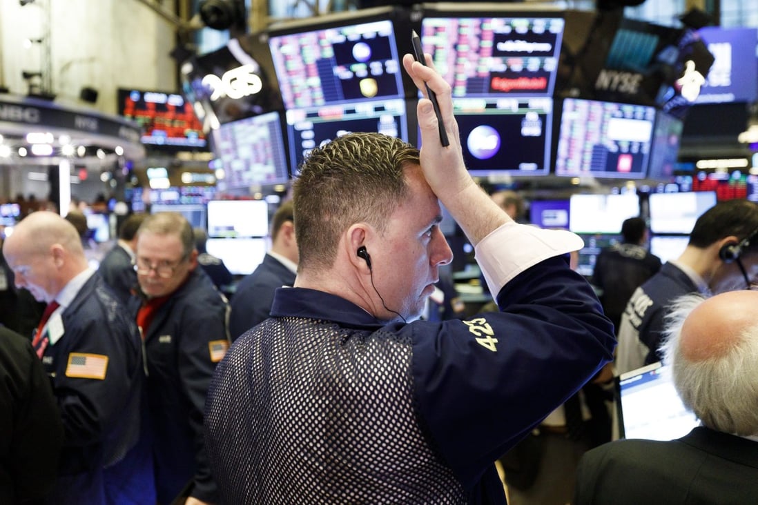 A trader wipes his forehead at the opening bell at the New York Stock Exchange on 16 March 2020. Photo: EPA-EFE