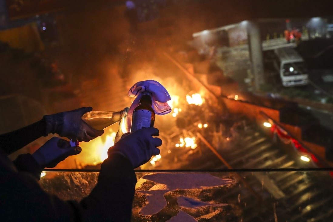 A petrol bomb is lit near Polytechnic University in Hung Hom, site of violent clashes between protesters and police in November 2019. Photo: Sam Tsang