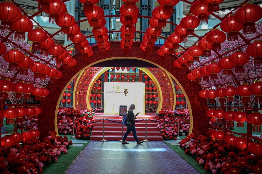 A woman walks in a shopping mall decorated with Lunar New Year lanterns in Kuala Lumpur. Photo: AFP
