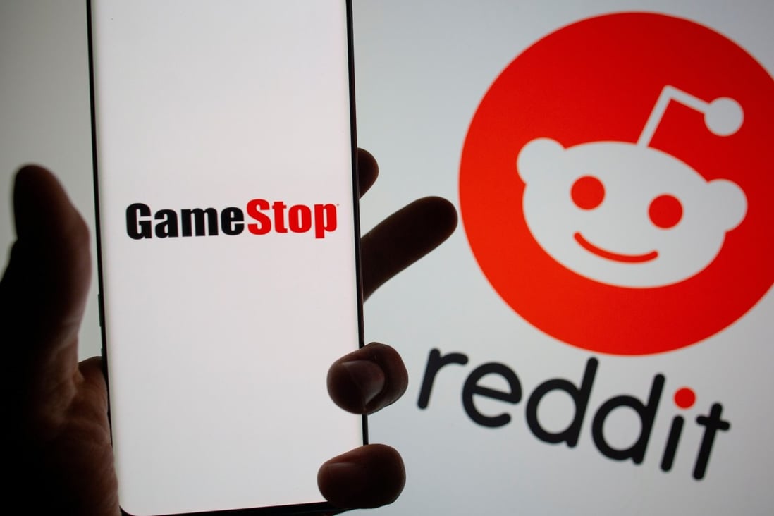 The GameStop logo is seen in front of displayed Reddit logo. Photo: Reuters