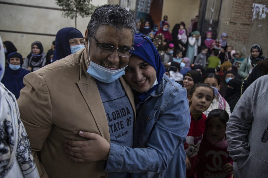 Al Jazeera journalist Mahmoud Hussein hugs his daughter after being released on Saturday by the Egyptian authorities after four years in detention. Photo: EPA-EFE