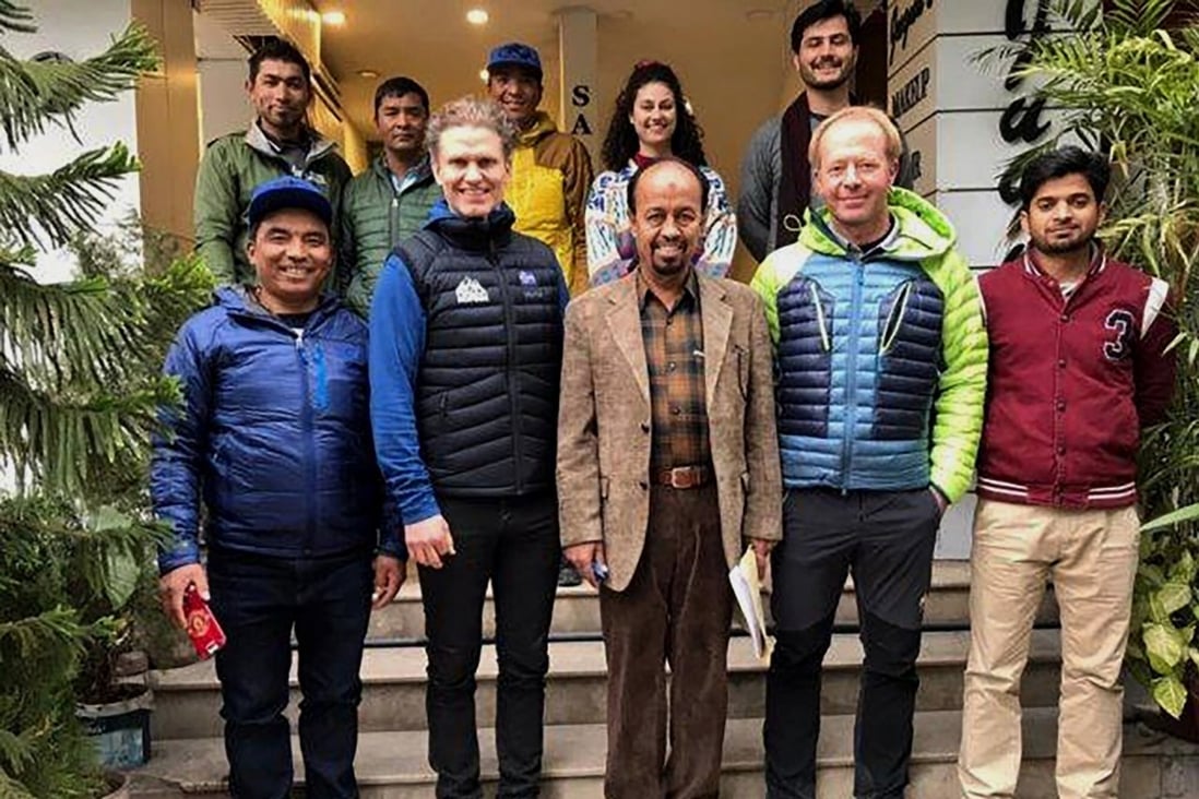 Mountaineer John Snorri, second left in front, with Karrar Haideri, a top official of the Alpine Club of Pakistan, front centre. Haideri said army helicopters were looking for Snorri and two of his climbing companions. Photo: AP