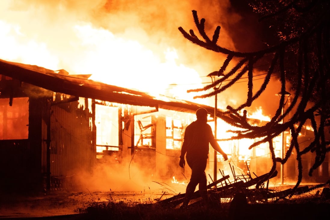 A public building burns during a protest after a police officer shot dead a street juggler in Panguipulli, Chile on Saturday. Photo: Reuters