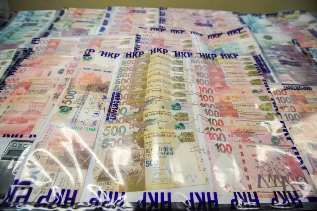 Police display cash seized in a crackdown on 14 illegal gambling establishments on Hong Kong Island. Photo: Felix Wong
