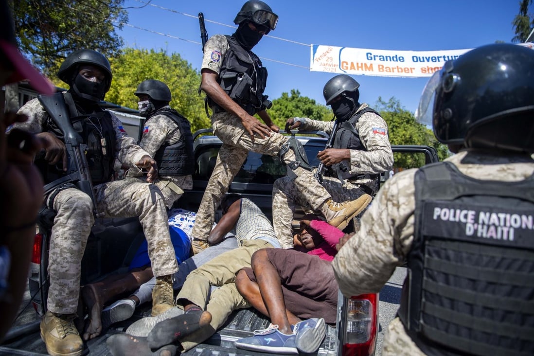 Police move detained demonstrators in the bed of a pick-up truck to a police station in Port-au-Prince, Haiti. Photo: AP