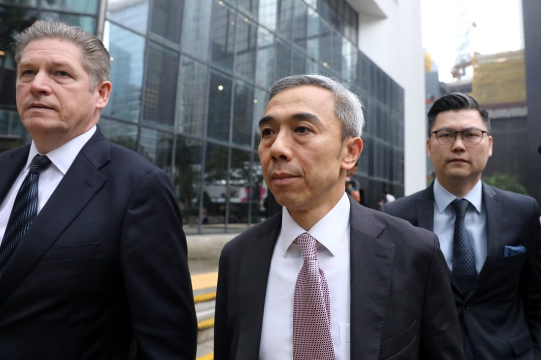 Former deputy secretary for economic development and labour Wilson Fung (centre) arrives at the District Court in Wan Chai in May 2019. Photo: Sam Tsang
