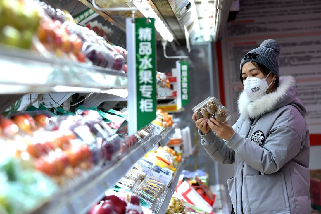 A woman shops at a supermarket in Shijiazhuang, Hebei province, on January 31. China must beware the risks of imported inflation from food, energy and raw materials. Photo: Xinhua