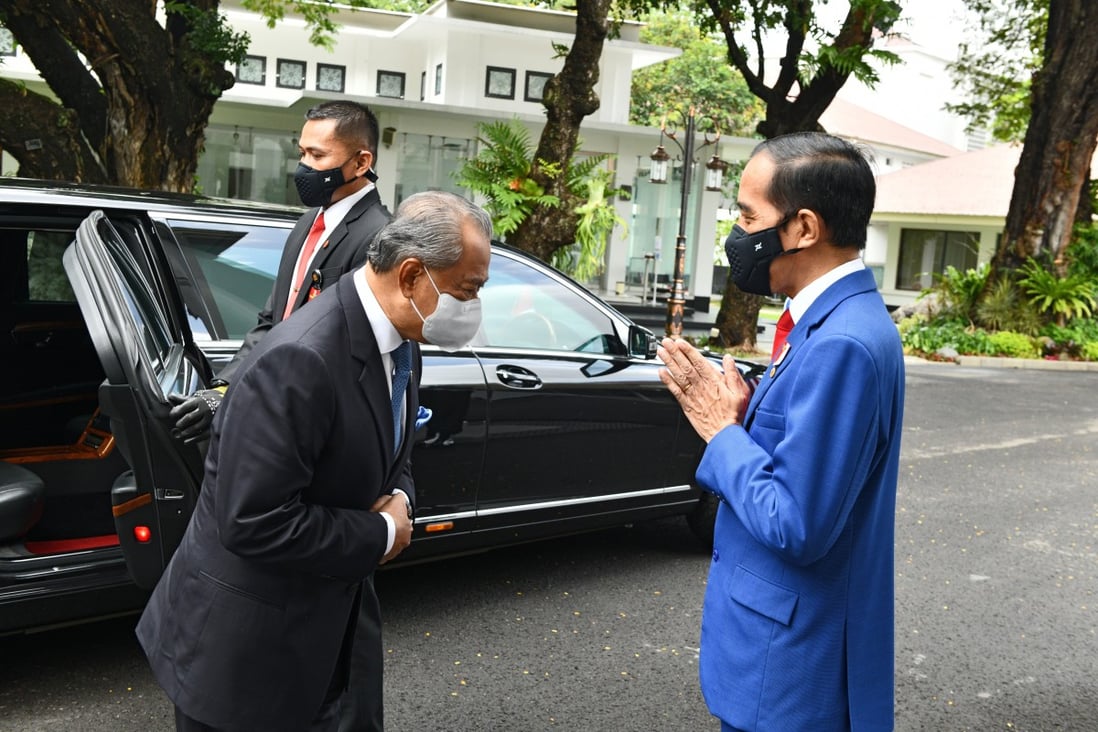 Malaysian Prime Minister Muhyiddin Yassin, left, greeting Indonesian President Joko Widodo before their meeting last week in Jakarta. Some Malaysians have speculated that the new coronavirus exemption order was implemented for Muhyiddin’s benefit. Photo: EPA-EFE