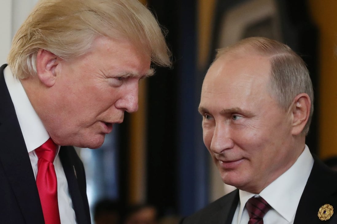 Donald Trump chats with Russia's President Vladimir Putin in 2018. File photo: AFP