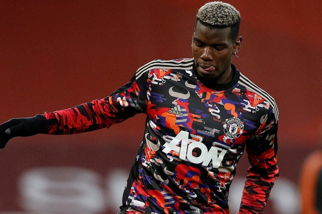 Manchester United’s French midfielder Paul Pogba warms up for an English Premier League match against Liverpool at Anfield wearing a Lunar New Year shirt. Photo: AFP