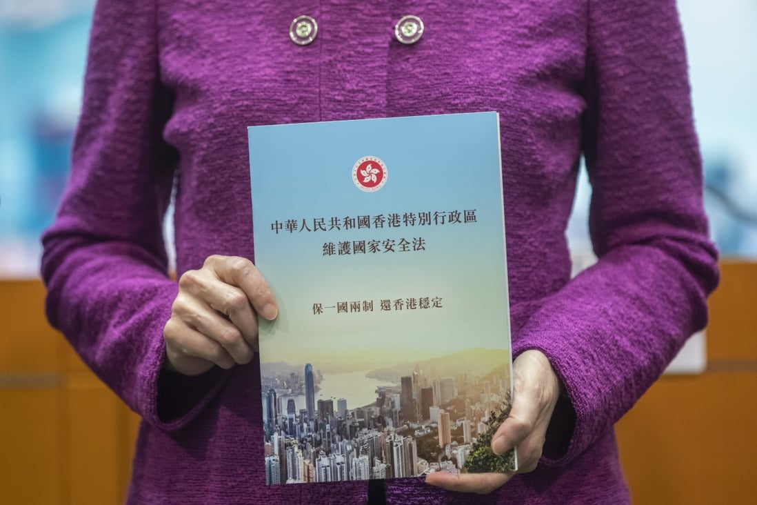 Hong Kong Chief Executive Carrie Lam Cheng Yuet-ngor holds up a copy of the national security law at a news conference in Hong Kong on July 1, the day after the law was imposed on the city by promulgation. Photo: Bloomberg
