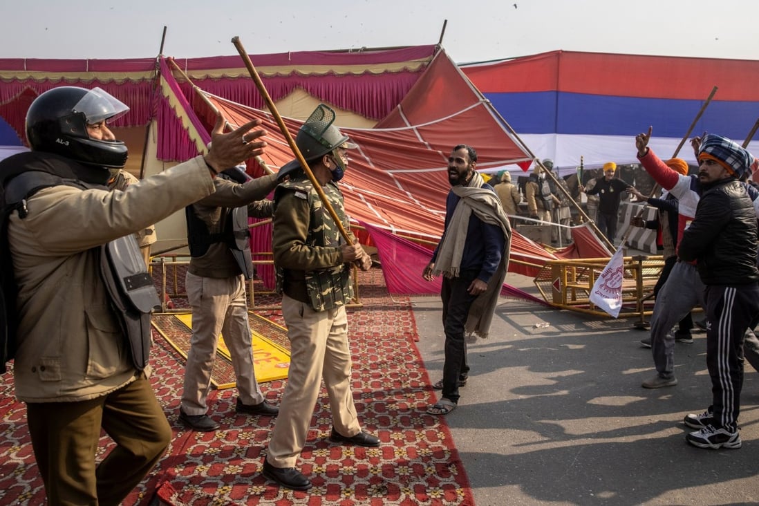 An Indian policeman wields a lathi (stick) in a clash with protesting farmers outside Delhi. The use of these batons has been criticised as brutal. Photo: Reuters